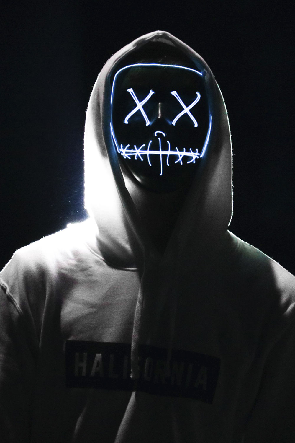 photograph of a person with glowing crosses for eyes and a mouth